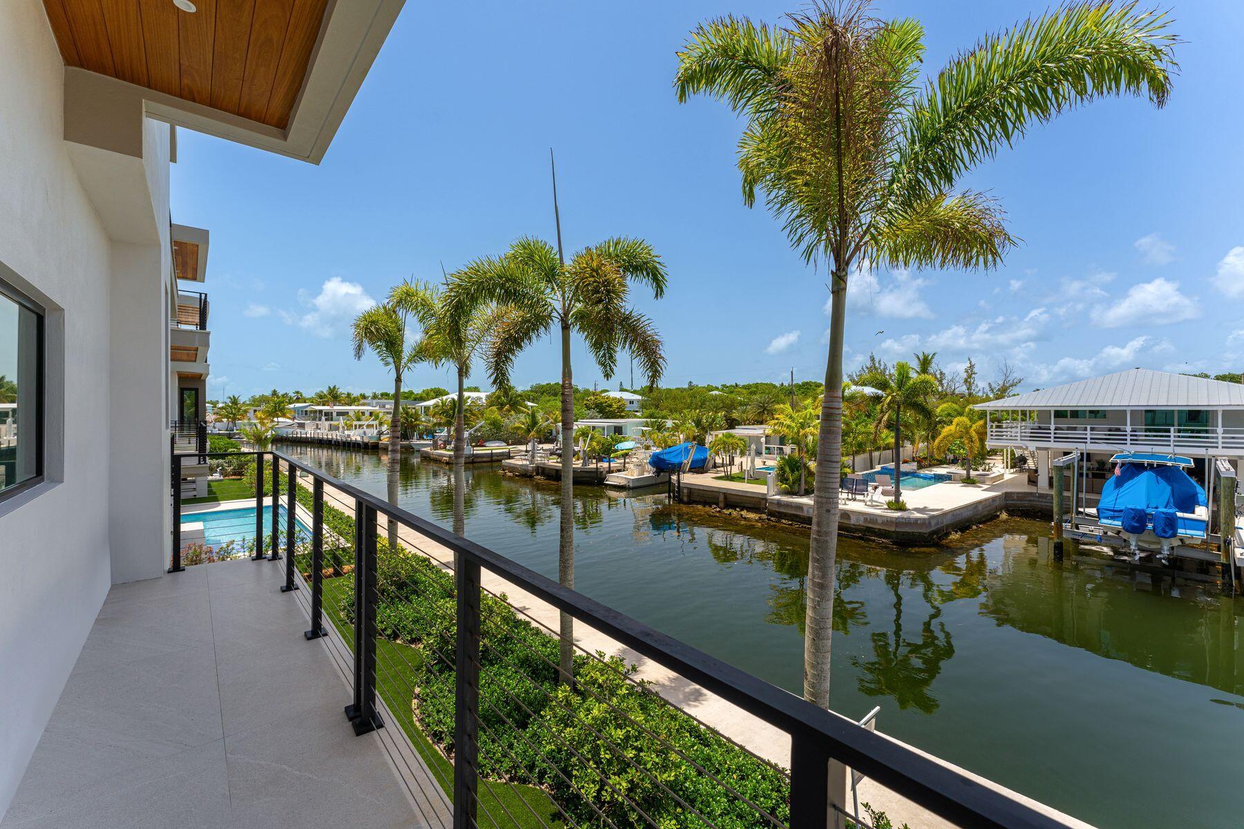 301 Buttonwood Circle, Unit B Key Largo, FL 33037 - Photo 29 of 40 a view of swimming pool from a balcony