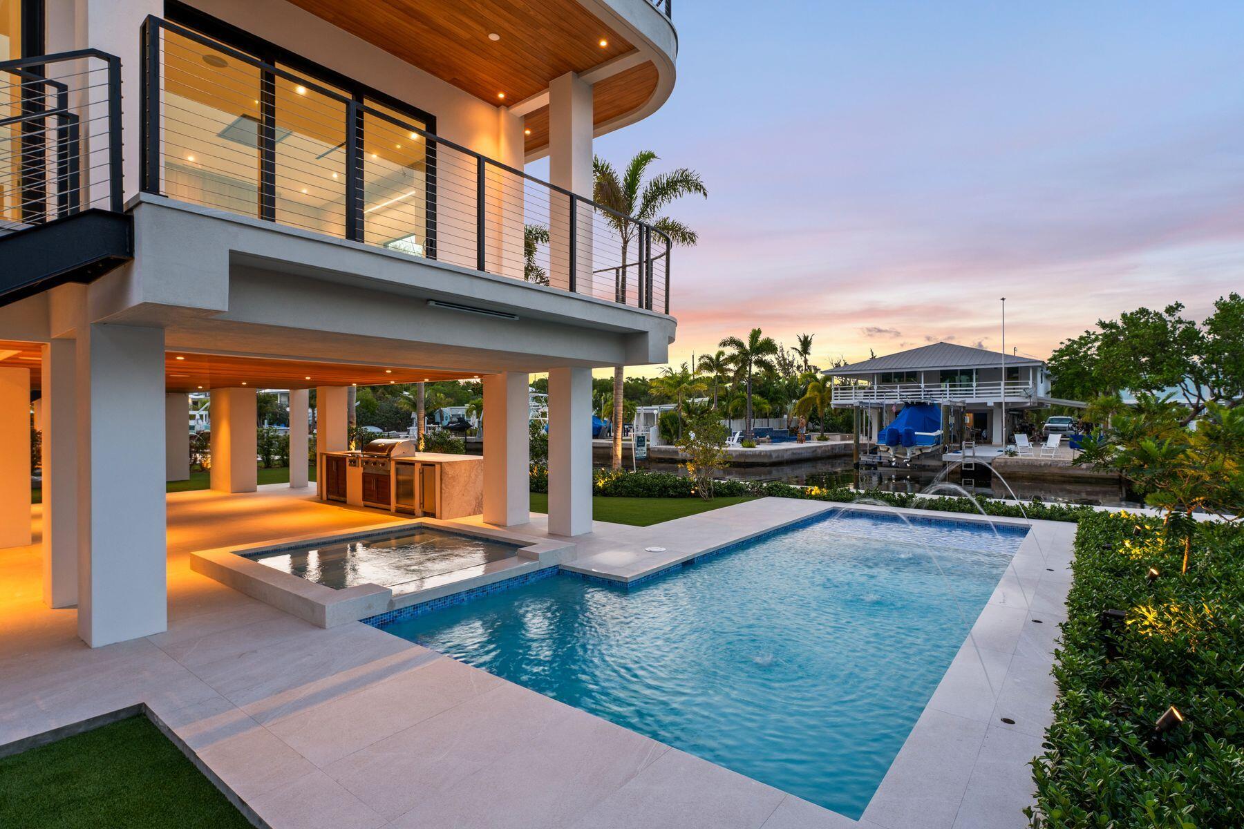 301 Buttonwood Circle, Unit B Key Largo, FL 33037 - Photo 33 of 40 a view of a house with sitting area and swimming pool