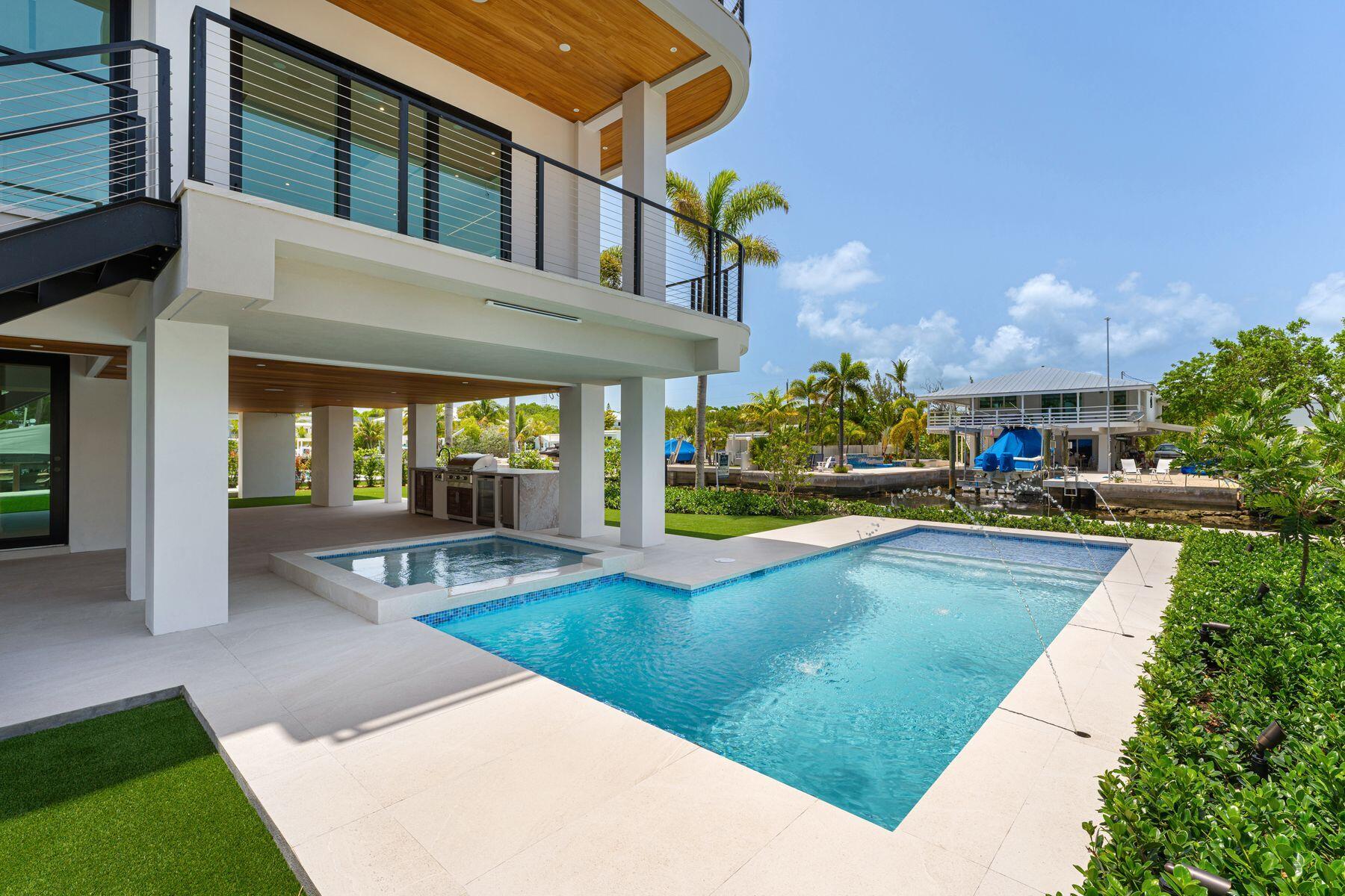 301 Buttonwood Circle, Unit B Key Largo, FL 33037 - Photo 4 of 40 a view of a house with sitting area and swimming pool