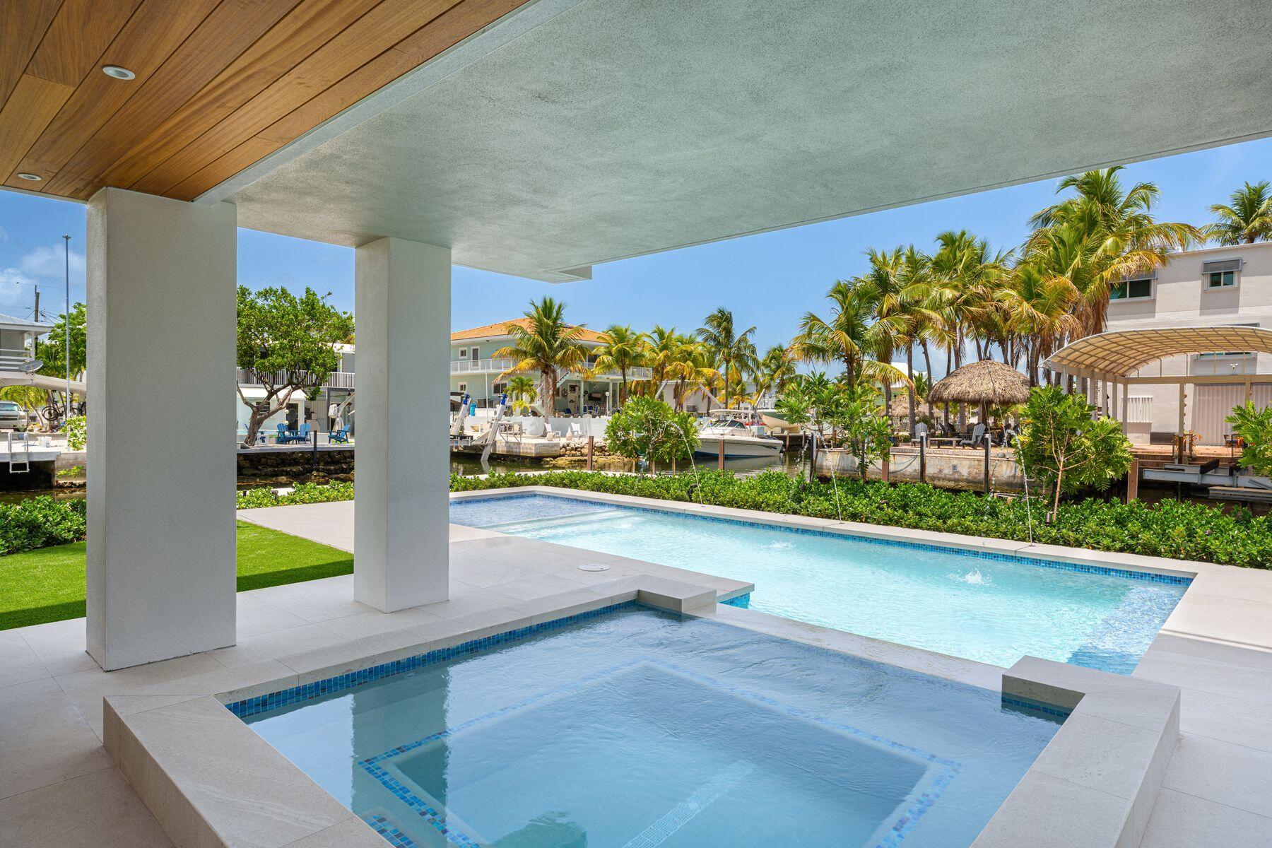 301 Buttonwood Circle, Unit B Key Largo, FL 33037 - Photo 5 of 40 a view of swimming pool with a yard
