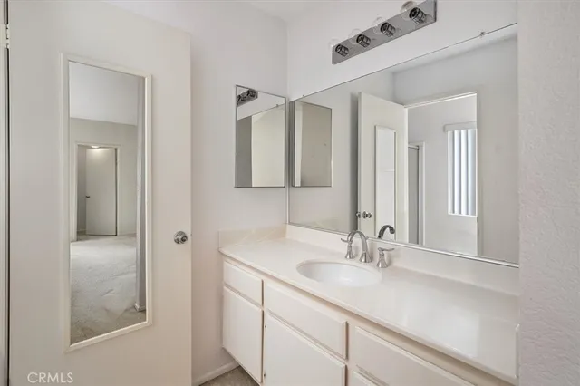 a bathroom with a sink double vanity and a mirror