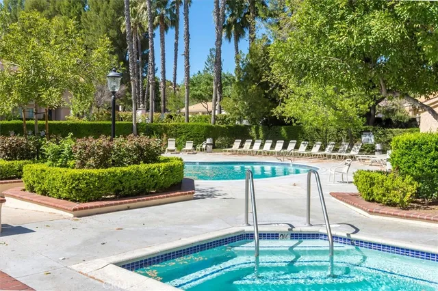 a view of a park with a bench and trees