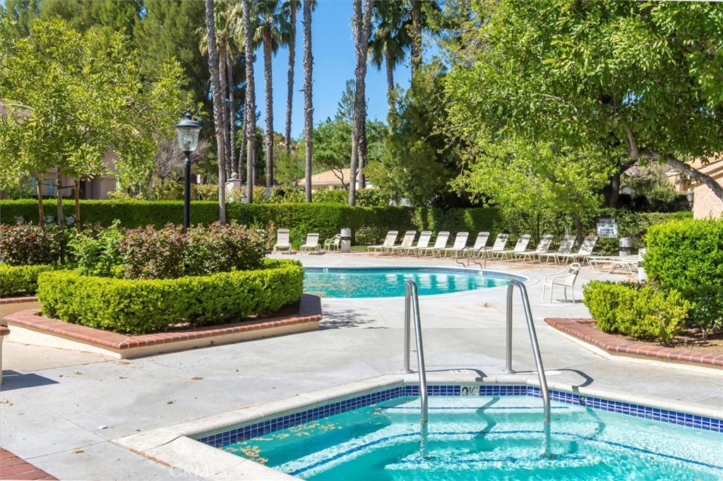 25126 Steinbeck Avenue, Unit D Stevenson Ranch, CA 91381 - Photo 18 of 22 a view of a park with a bench and trees