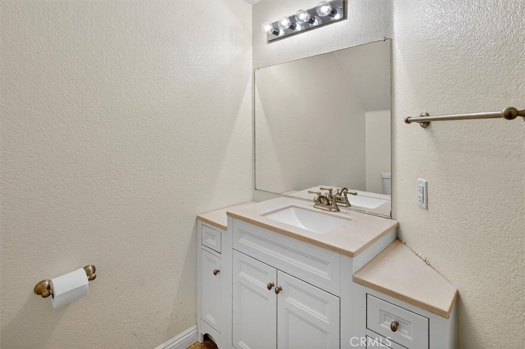 25126 Steinbeck Avenue, Unit D Stevenson Ranch, CA 91381 - Photo 8 of 22 a bathroom with a sink and a mirror