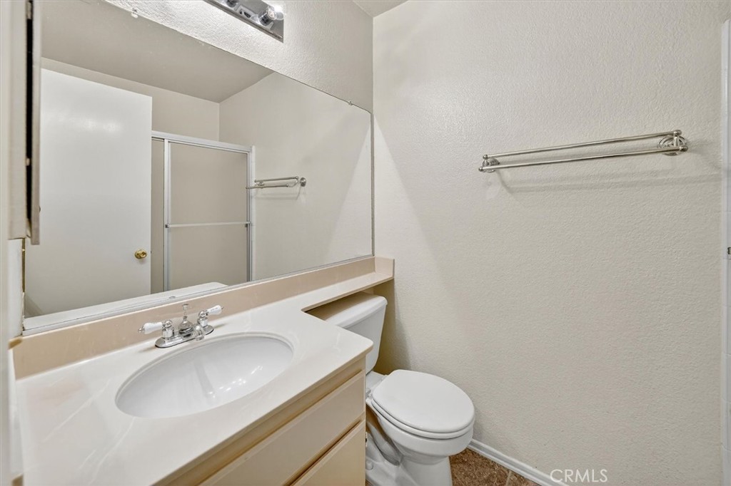 25126 Steinbeck Avenue, Unit D Stevenson Ranch, CA 91381 - Photo 10 of 22 a bathroom with a sink toilet and shower