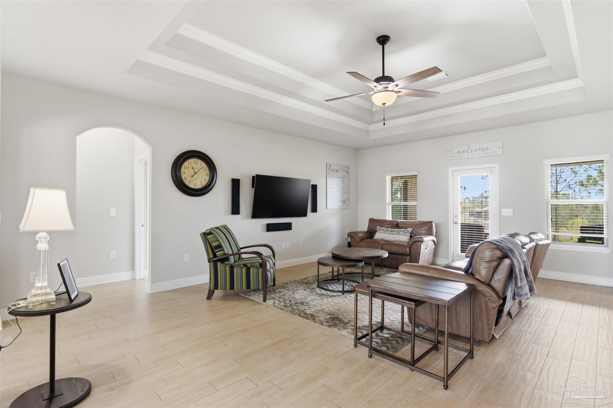 2677 Tulip Hill Road Pace, FL 32571 - Photo 17 of 35 a living room with furniture a flat screen tv and a window