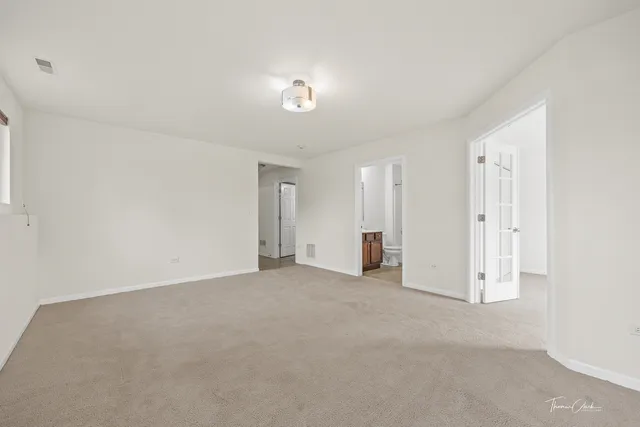 an empty room with a window and a ceiling fan