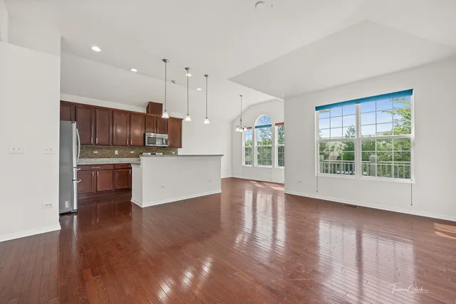 a view of kitchen with wooden floor and electronic appliances