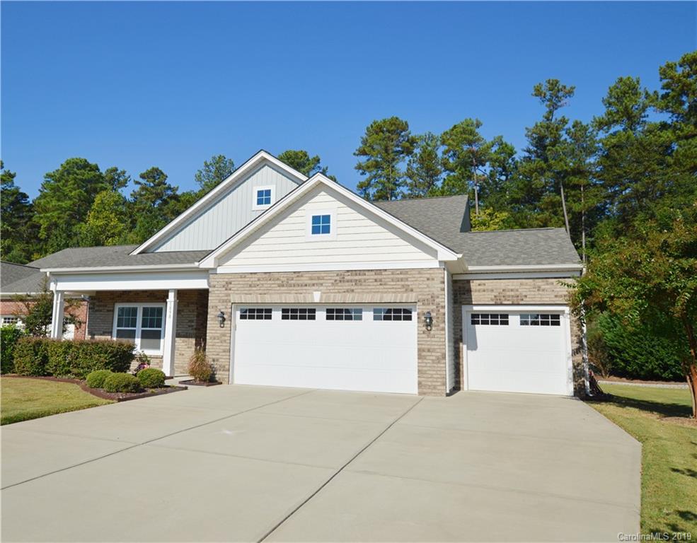 1898 Larkspur Way Tega Cay, SC 29708 - Photo 1 of 35 a front view of a house with a yard and garage