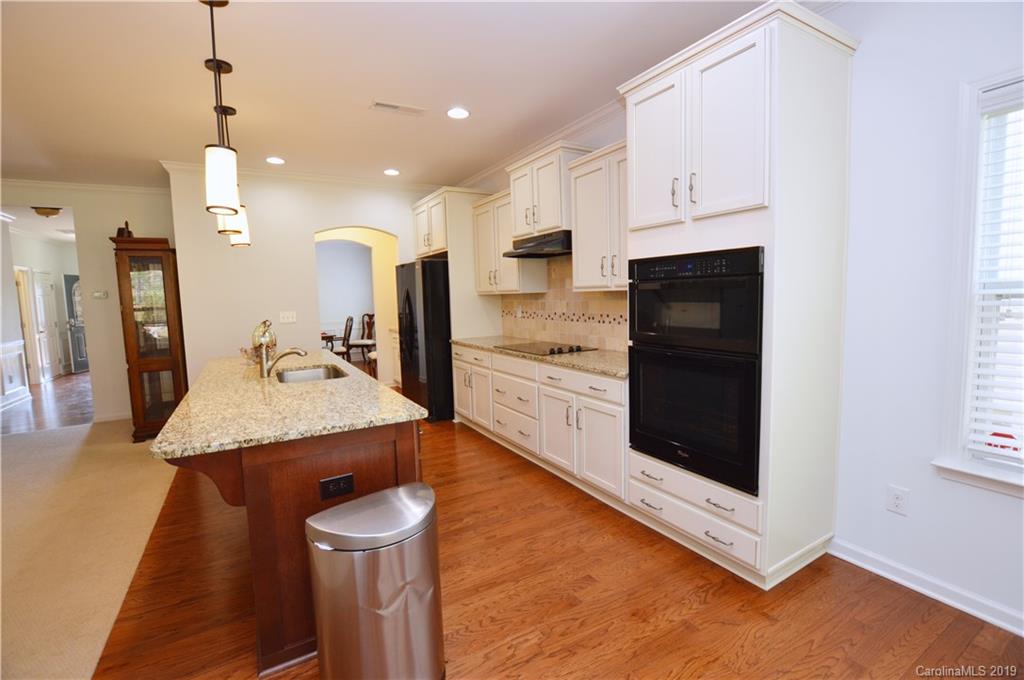 1898 Larkspur Way Tega Cay, SC 29708 - Photo 14 of 35 a kitchen with stainless steel appliances granite countertop a sink a stove and a refrigerator