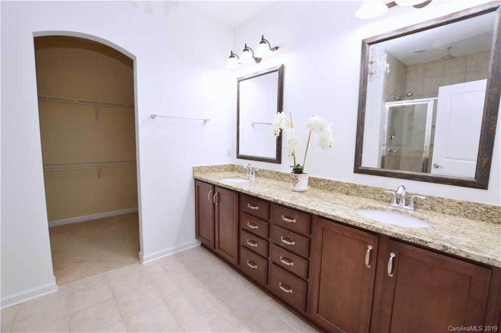 1898 Larkspur Way Tega Cay, SC 29708 - Photo 20 of 35 a bathroom with a granite countertop sink and a mirror