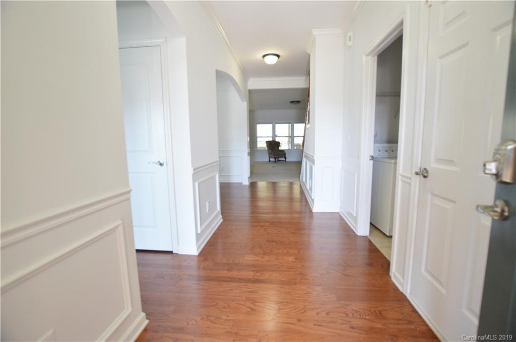 1898 Larkspur Way Tega Cay, SC 29708 - Photo 4 of 35 a view of a hallway with a wooden floor
