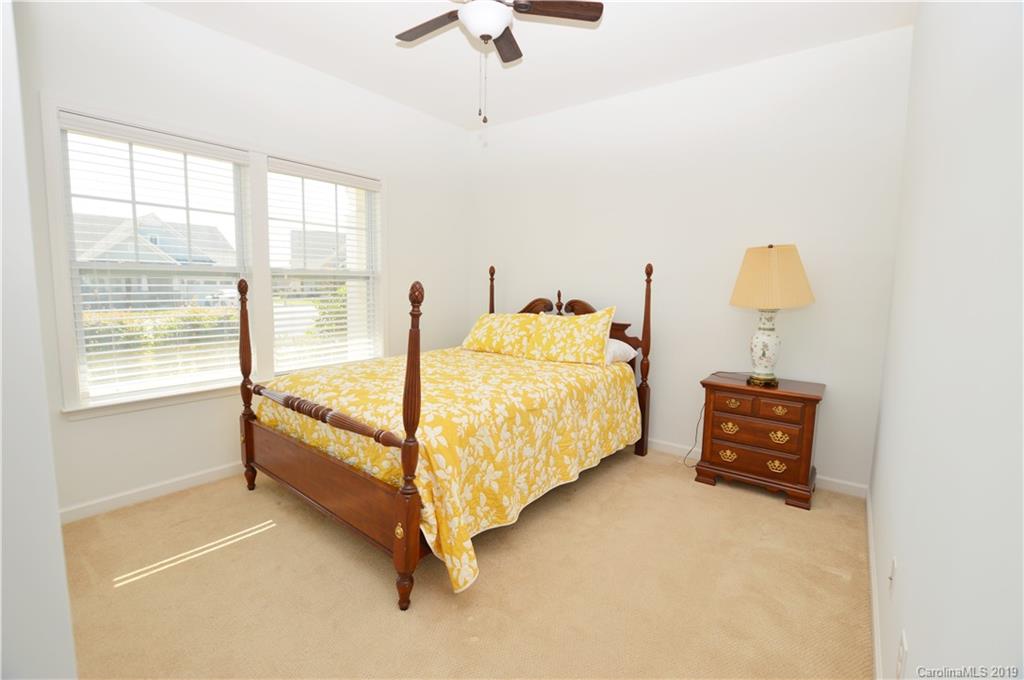 1898 Larkspur Way Tega Cay, SC 29708 - Photo 5 of 35 a bedroom with a bed and a chandelier