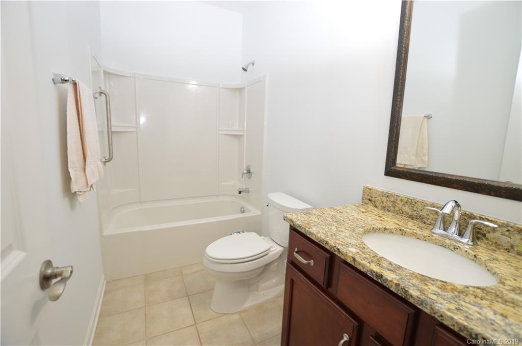 1898 Larkspur Way Tega Cay, SC 29708 - Photo 7 of 35 a bathroom with a granite countertop sink a toilet and bathtub