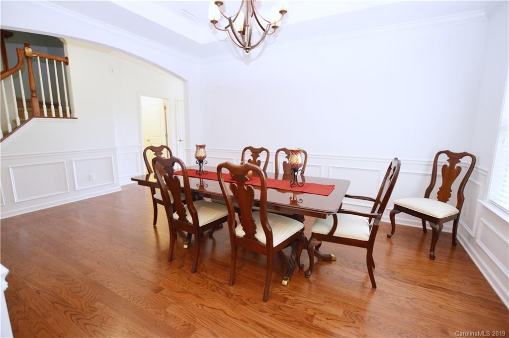 1898 Larkspur Way Tega Cay, SC 29708 - Photo 8 of 35 a dining room with furniture and wooden floor