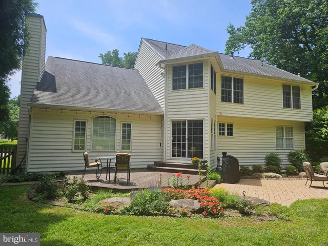 a front view of a house with a yard and outdoor seating