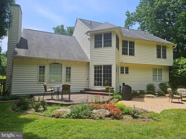 a front view of a house with a yard and outdoor seating
