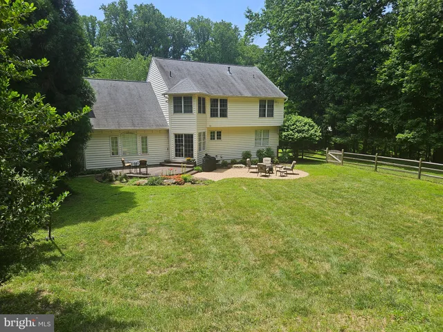 a view of a house with swimming pool and chairs