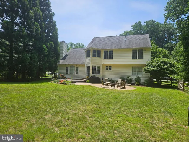 a front view of a house with swimming pool having outdoor seating