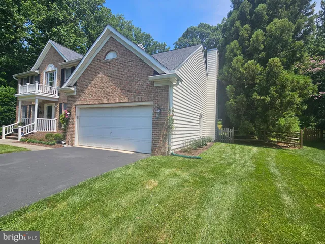 a front view of a house with a garden and yard