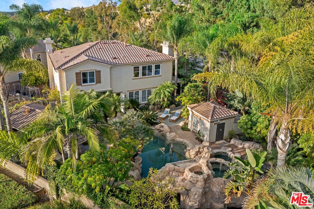 a aerial view of a house with a yard and fountain