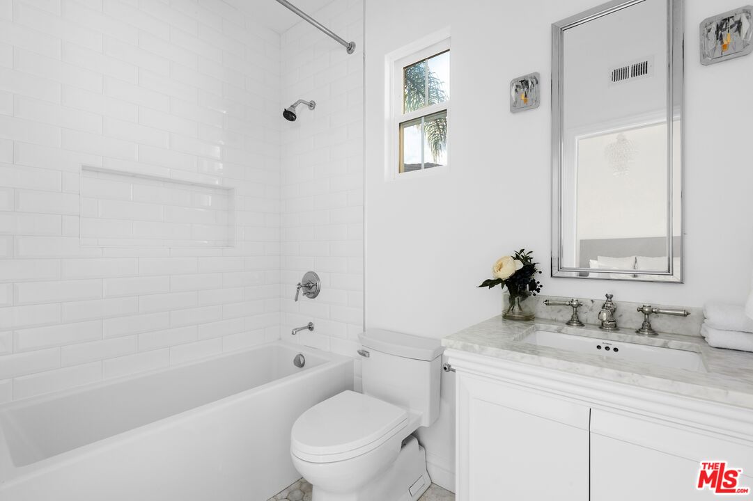 2 Arborwood Irvine, CA 92620 - Photo 15 of 26 a bathroom with a toilet a sink a mirror a bathtub and vanity