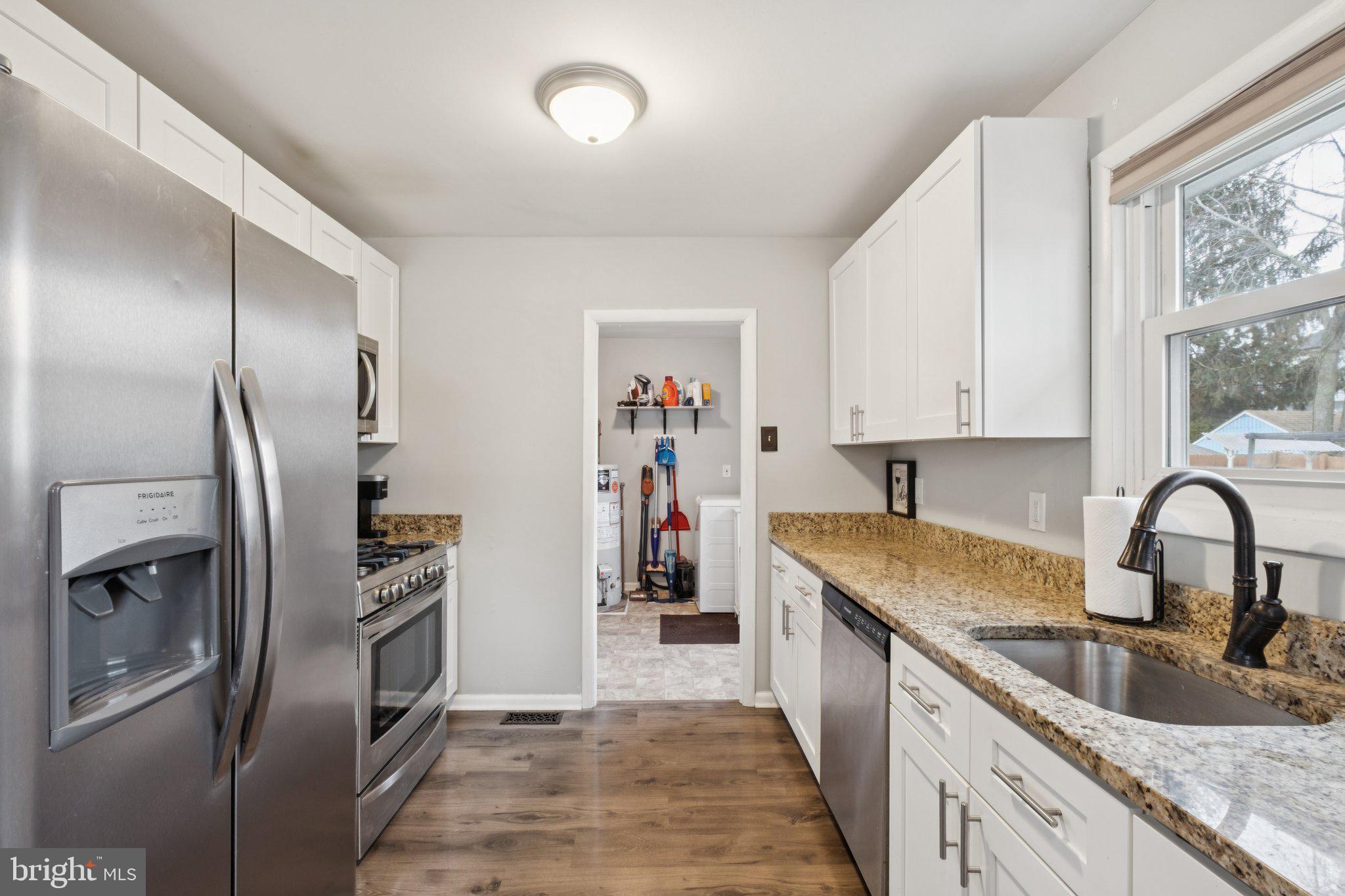 614 Brooke Avenue Magnolia, NJ 08049 - Photo 12 of 33 a kitchen with stainless steel appliances granite countertop a refrigerator and a sink