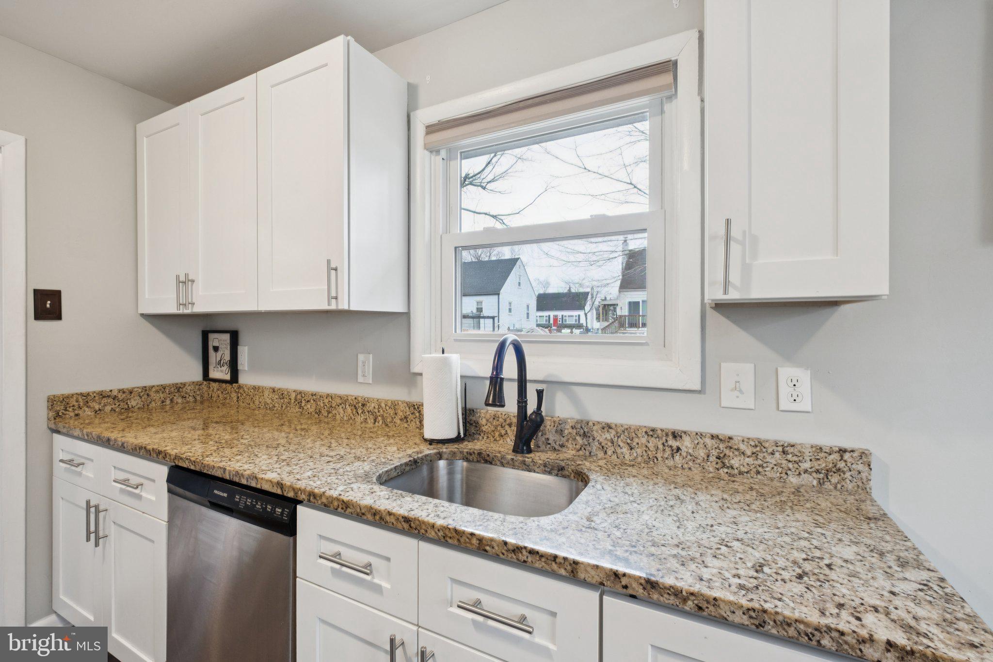 614 Brooke Avenue Magnolia, NJ 08049 - Photo 13 of 33 a kitchen with granite countertop a sink window and cabinets