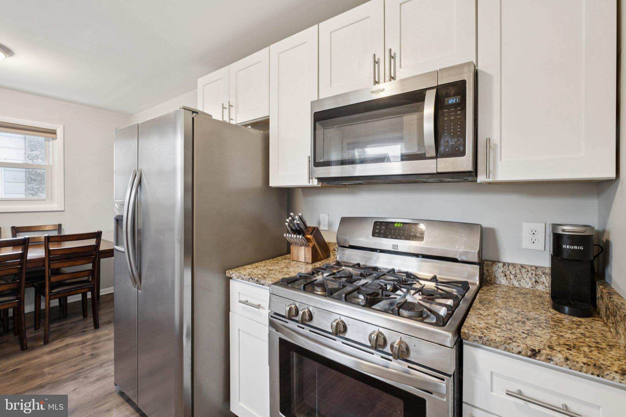 614 Brooke Avenue Magnolia, NJ 08049 - Photo 15 of 33 a kitchen with stainless steel appliances granite countertop a stove a microwave and a refrigerator