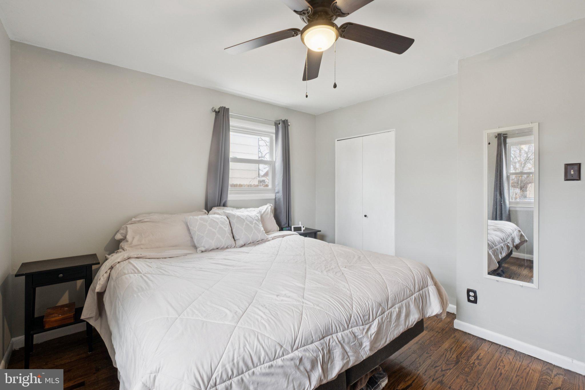 614 Brooke Avenue Magnolia, NJ 08049 - Photo 17 of 33 a bedroom with a large bed and a chandelier