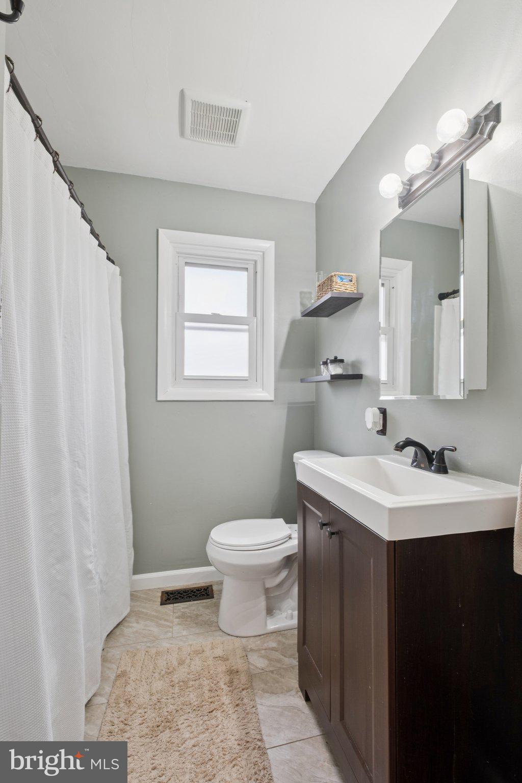 614 Brooke Avenue Magnolia, NJ 08049 - Photo 20 of 33 a bathroom with a sink toilet and mirror