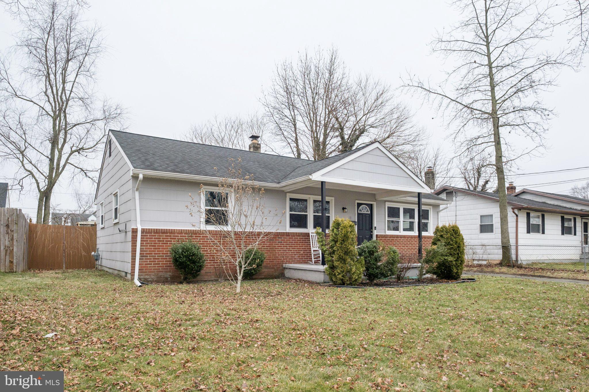 614 Brooke Avenue Magnolia, NJ 08049 - Photo 3 of 33 a front view of a house with a yard and garage