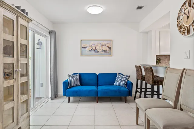 a view of a livingroom with furniture and a dining table