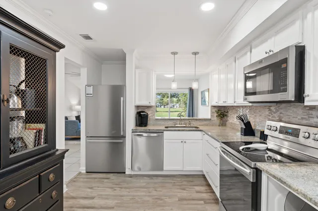 a kitchen with a refrigerator stove and sink