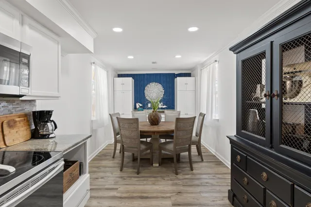 a view of a dining room with furniture and wooden floor