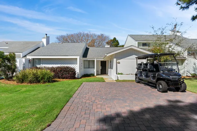 a view of a house with a yard and sitting area