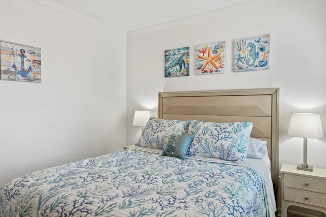 a bedroom with a bed and painting on the wall