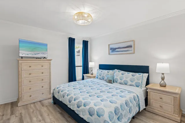 a bedroom with a bed and a chandelier