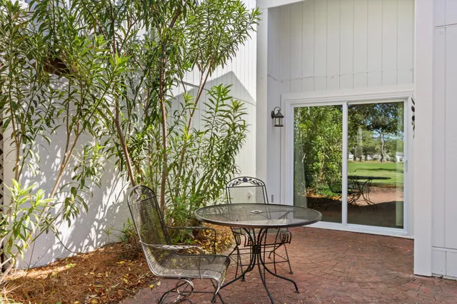a outdoor space with patio the couches and a dining table with large trees