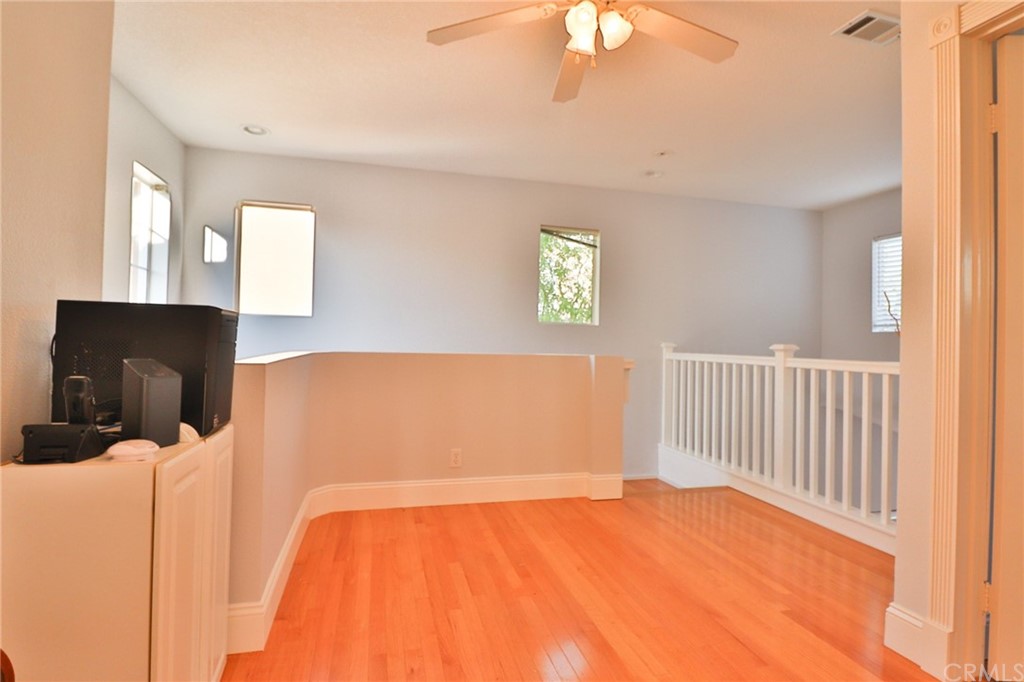 6 Rue Monet Lake Forest, CA 92610 - Photo 18 of 24 The loft from the secondary bedroom toward the stairs from below. The railing overlooks the living room.