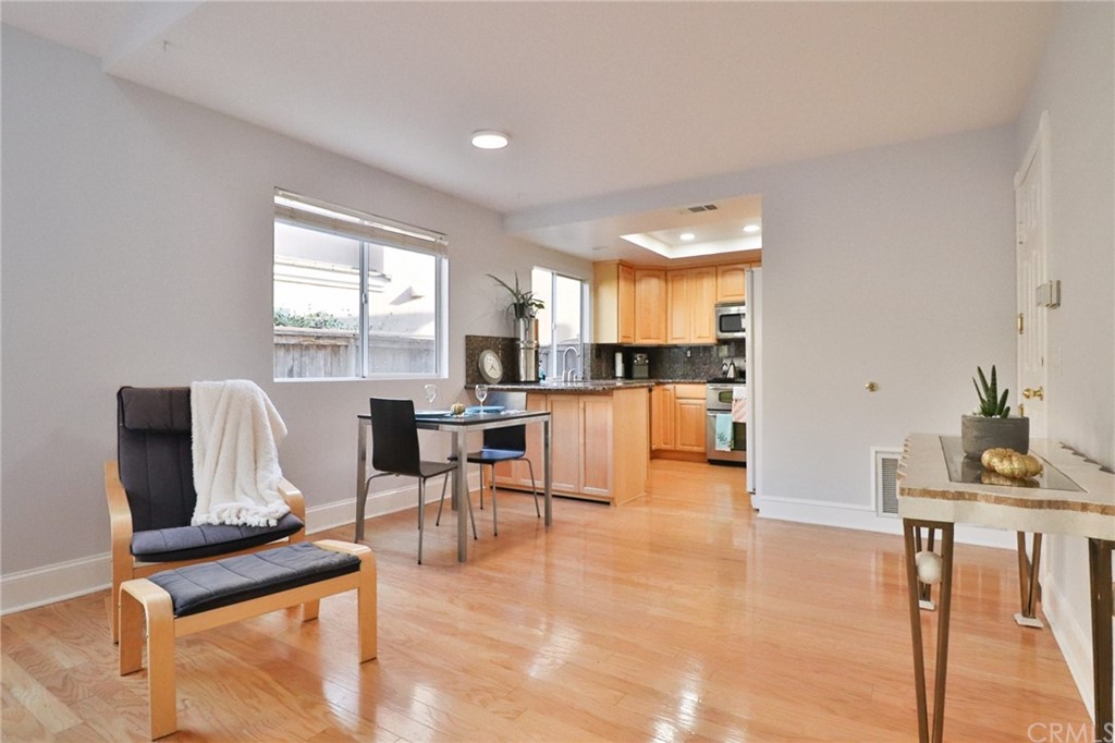 6 Rue Monet Lake Forest, CA 92610 - Photo 7 of 24 The living room/dining room toward the kitchen and entry door to the garage on the right.