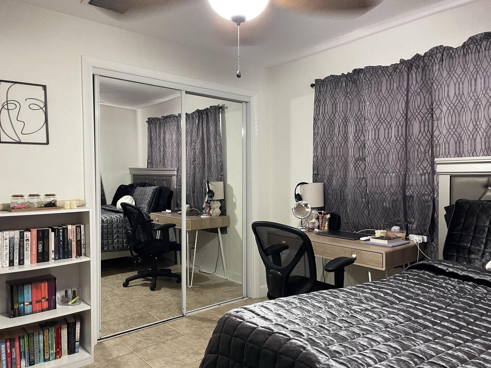 664 Colson Drive Key Largo, FL 33037 - Photo 16 of 36 a bedroom with a bed a study table and a book shelf