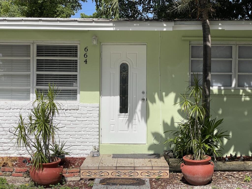 664 Colson Drive Key Largo, FL 33037 - Photo 2 of 36 a potted plant sitting in front of a house