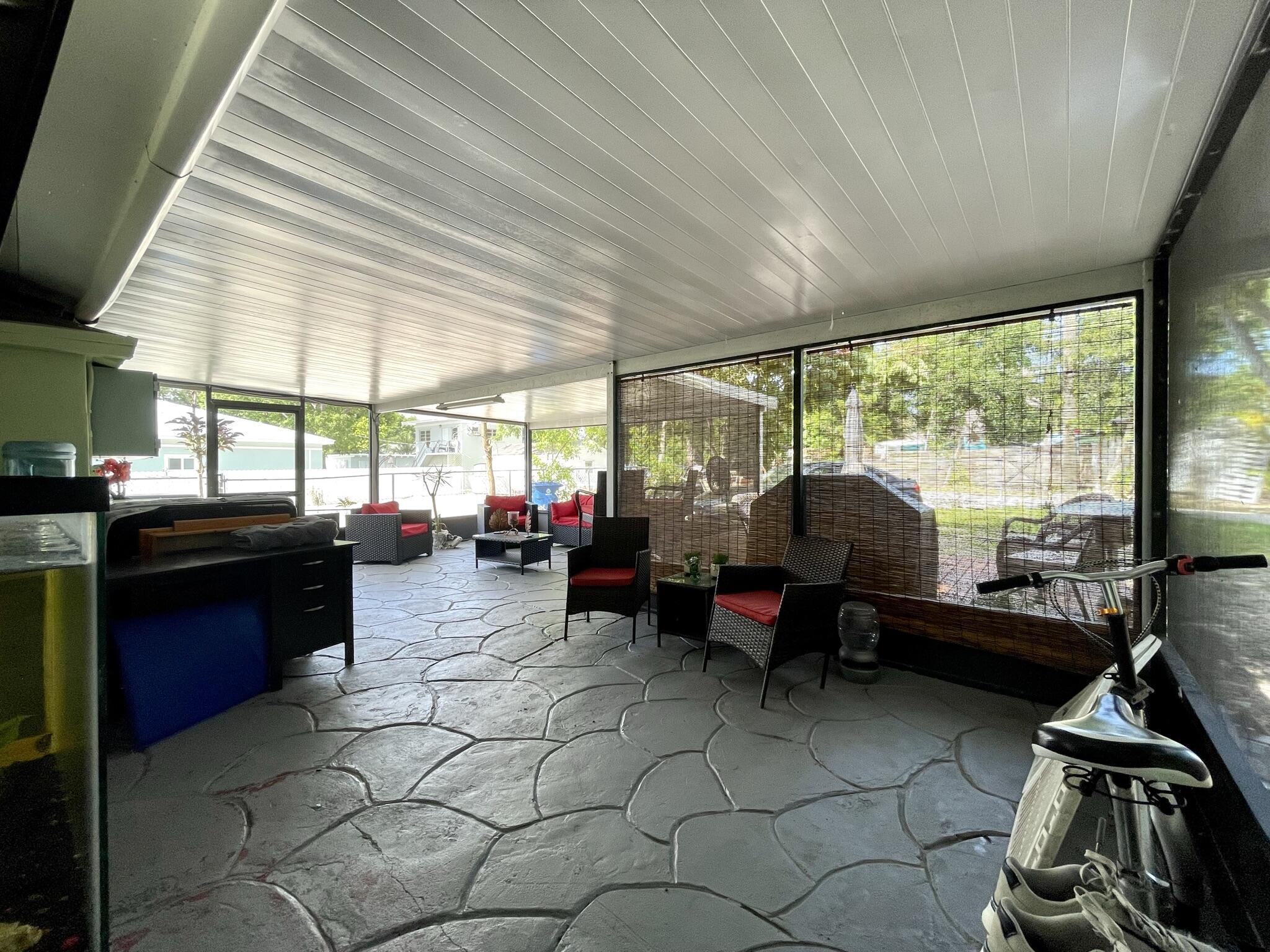 664 Colson Drive Key Largo, FL 33037 - Photo 27 of 36 a living room with furniture and a floor to ceiling window