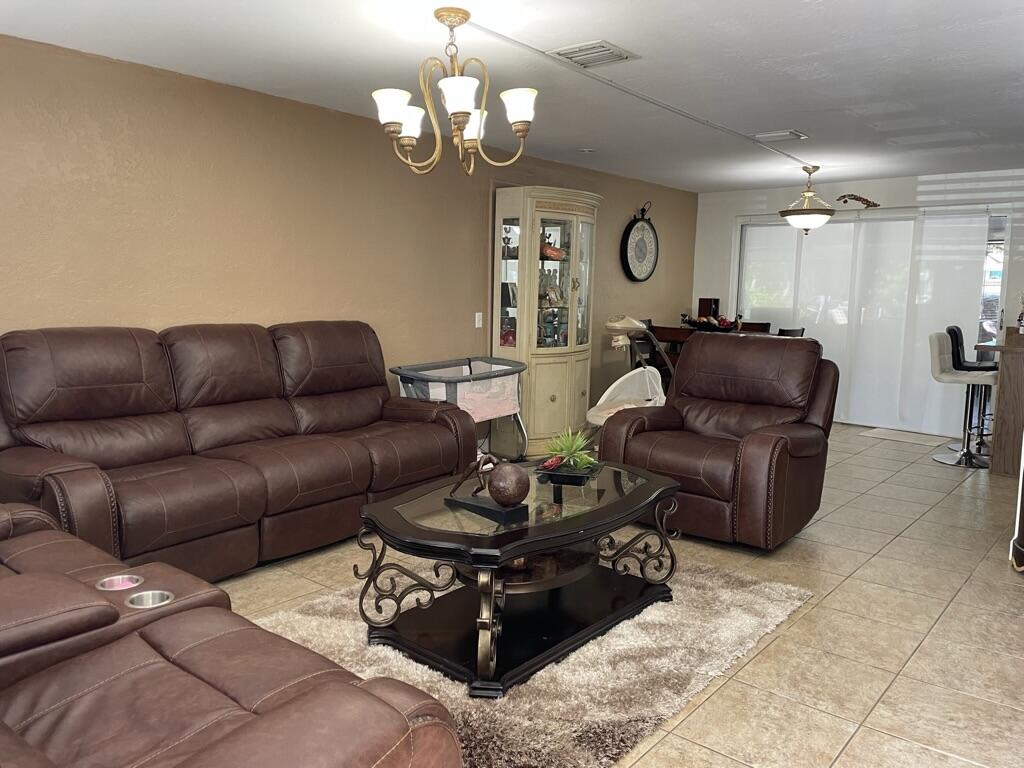 664 Colson Drive Key Largo, FL 33037 - Photo 3 of 36 a living room with furniture chandelier and a chandelier