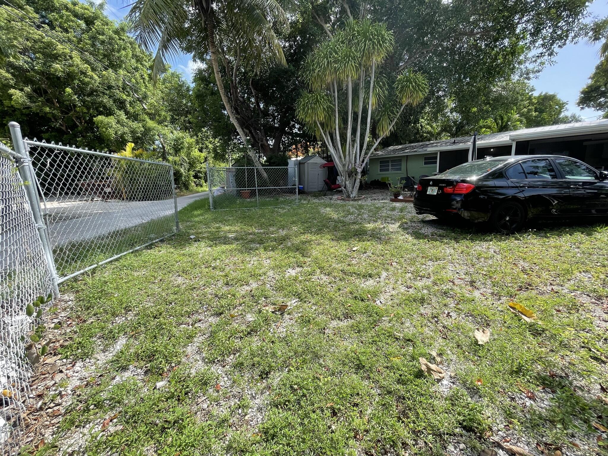 664 Colson Drive Key Largo, FL 33037 - Photo 31 of 36 a view of a yard with a car parked in it