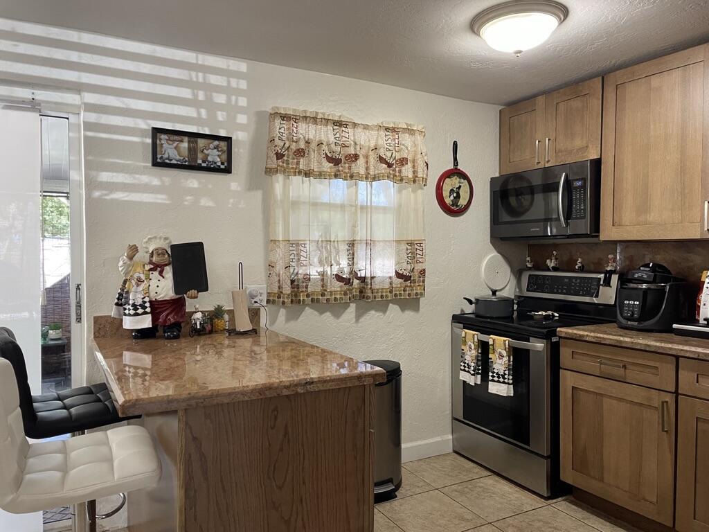 664 Colson Drive Key Largo, FL 33037 - Photo 8 of 36 a kitchen with stainless steel appliances granite countertop a stove and a sink
