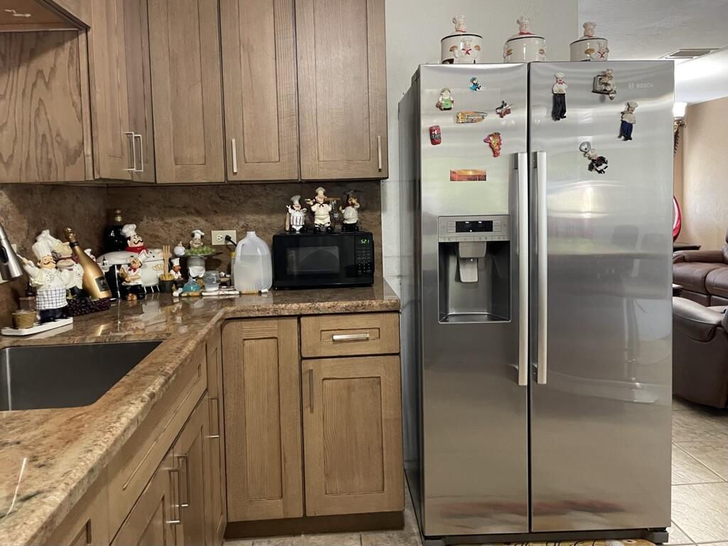 664 Colson Drive Key Largo, FL 33037 - Photo 9 of 36 a kitchen with a refrigerator and a sink