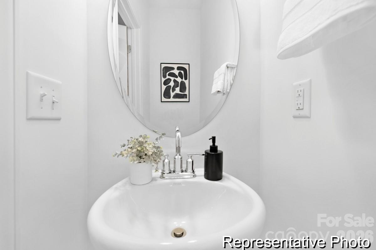 155 Soft Breeze Bend, Unit 286B Locust, NC 28097 - Photo 12 of 28 a bathroom with a sink and a mirror