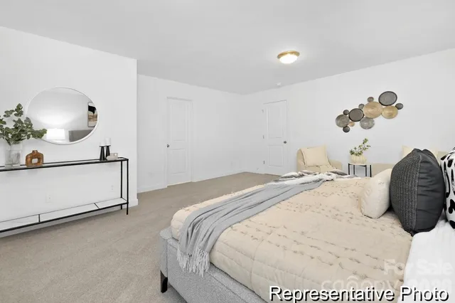 a bedroom with a bed and a lamp